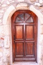 Four paneled, wood, front door with arching top of,four glass panels, in Provence France