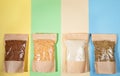 Four paper bags with cereals and legumes on four-colored backdrop. Zero Waste and No plastic Concept. Top view