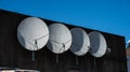 Four parabolic antennae on the facade of a building.. Royalty Free Stock Photo