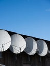 Four parabolic antennae on the facade of a building.. Royalty Free Stock Photo
