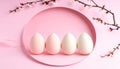 Four pastel Easter eggs arranged in a row on a pink circular plate spring Royalty Free Stock Photo