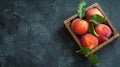 Four peaches in wooden crate on table Royalty Free Stock Photo