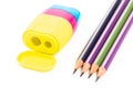 Four pencils and a multi-colored sharpener