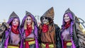 Four people disguised as cartoon characters with beautiful and colorful costumes parade at the Carnival of Viareggio, Italy