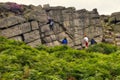 Group of people rock climbing in the Peak District