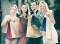 Four people holding paper bags Royalty Free Stock Photo