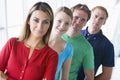 Four people standing in corridor smiling Royalty Free Stock Photo