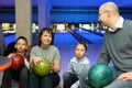 Four persons sit communicate in bowling club