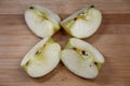 Four pieces of apple on wooden background Royalty Free Stock Photo