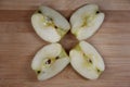 Four pieces of apple on wooden background Royalty Free Stock Photo