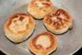 Four pieces of fried bhatura in pan