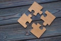 Four pieces of the puzzle are combined into a single whole on a blue wooden background. Royalty Free Stock Photo