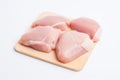 Four pieces of raw chicken on a cutting board, AI