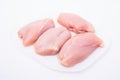 Four pieces of raw chicken on a white plate, AI