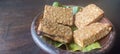 four pieces of tempeh on the earthware plate Royalty Free Stock Photo