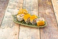 Four pieces of uramaki california roll prawn with nori seaweed and fish roe