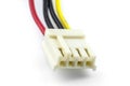 A four-pin female plug for powering a floppy drive coming from a computer power supply, isolated on a white background.