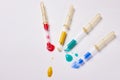 Four pipettes with a multi-colored liquid on a white background