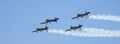 Four piston propeller aerobatic aicraft during display.