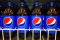 Four plastic two-liter bottles of Pepsi on store shelf