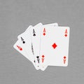 Four playing cards depicting aces