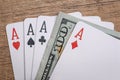 Four poker aces with dollar bills Royalty Free Stock Photo