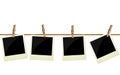 Four polaroid pictures hanging on rope Royalty Free Stock Photo