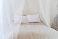 Four-poster bed with two pillows. Scandinavian simplicity design. Eco loft apartments. Royalty Free Stock Photo