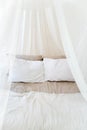 Four-poster bed with two pillows. Scandinavian simplicity design. Eco loft apartments. Royalty Free Stock Photo