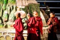 Four praying young buddhism monks at the Swayambhunath temple