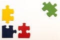Four primary-colored hand-painted pieces of a jigsaw puzzle