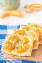 Four puff pastries with pumpkin, garlic and cheese