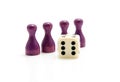 Four purple wooden pawns with dice Royalty Free Stock Photo