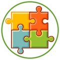 Four puzzle pieces connected inside a green circle, a symbol of teamwork and unity Royalty Free Stock Photo