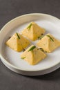 Four pyramid shaped herb cheese bites served with chives Royalty Free Stock Photo