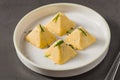 Four pyramid shaped herb cheese bites served with chives Royalty Free Stock Photo