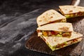 Four quesadilla pieces on dark background Royalty Free Stock Photo