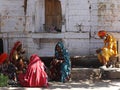 Four Rajasthani women and a sadhu having breakfast, Pushkar, India