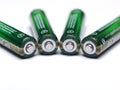 Four Recyclable AAA Batteries arranged on their sides with the p