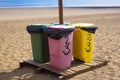 Four recycle bins for different waste. Paper, glass, food, plastic. Beach, sand Royalty Free Stock Photo