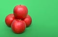 Four red apples on the green background Royalty Free Stock Photo