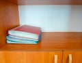 Four red and blue folders on a wooden shelf in the cabinet Royalty Free Stock Photo