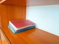 Four red and blue folders on a wooden shelf in the cabinet Royalty Free Stock Photo