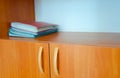 Four red and blue folders on a wooden shelf in the cabinet Royalty Free Stock Photo