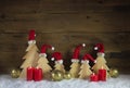 Four red burning advent candles with carved christmas trees on w Royalty Free Stock Photo