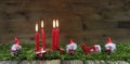 Four red burning advent candles. Christmas background with small Royalty Free Stock Photo