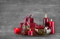 Four red burning advent candles on a grey shabby xmas background