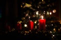 Four red candles - the first lighted candle of the first Sunday of Advent festival before Christmas with tree and decoration in ba Royalty Free Stock Photo