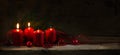 Four red candles, two of them burning on the second advent, christmas decoration with spruce twigs and baubles on a rustic Royalty Free Stock Photo