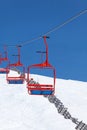 Four red chairs of ski lift Royalty Free Stock Photo